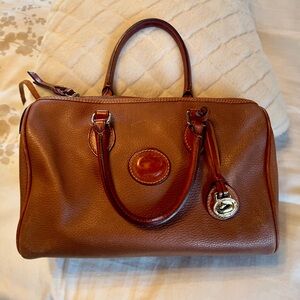 Dooney & Bourke satchel style cognac leather purse with 2 leather handles.